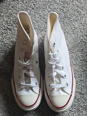 Converse White Canvas Kids High-Top Sneakers with Red Accents.